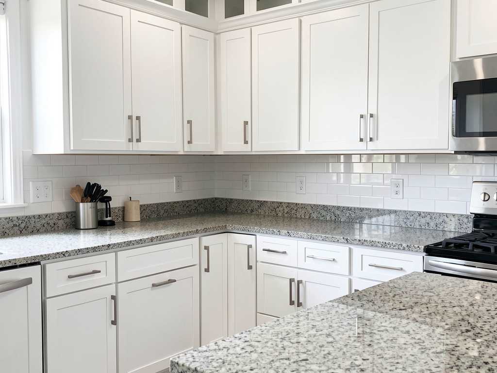 Completed kitchen cabinet installation Finished kitchen with installed white cabinets and countertops